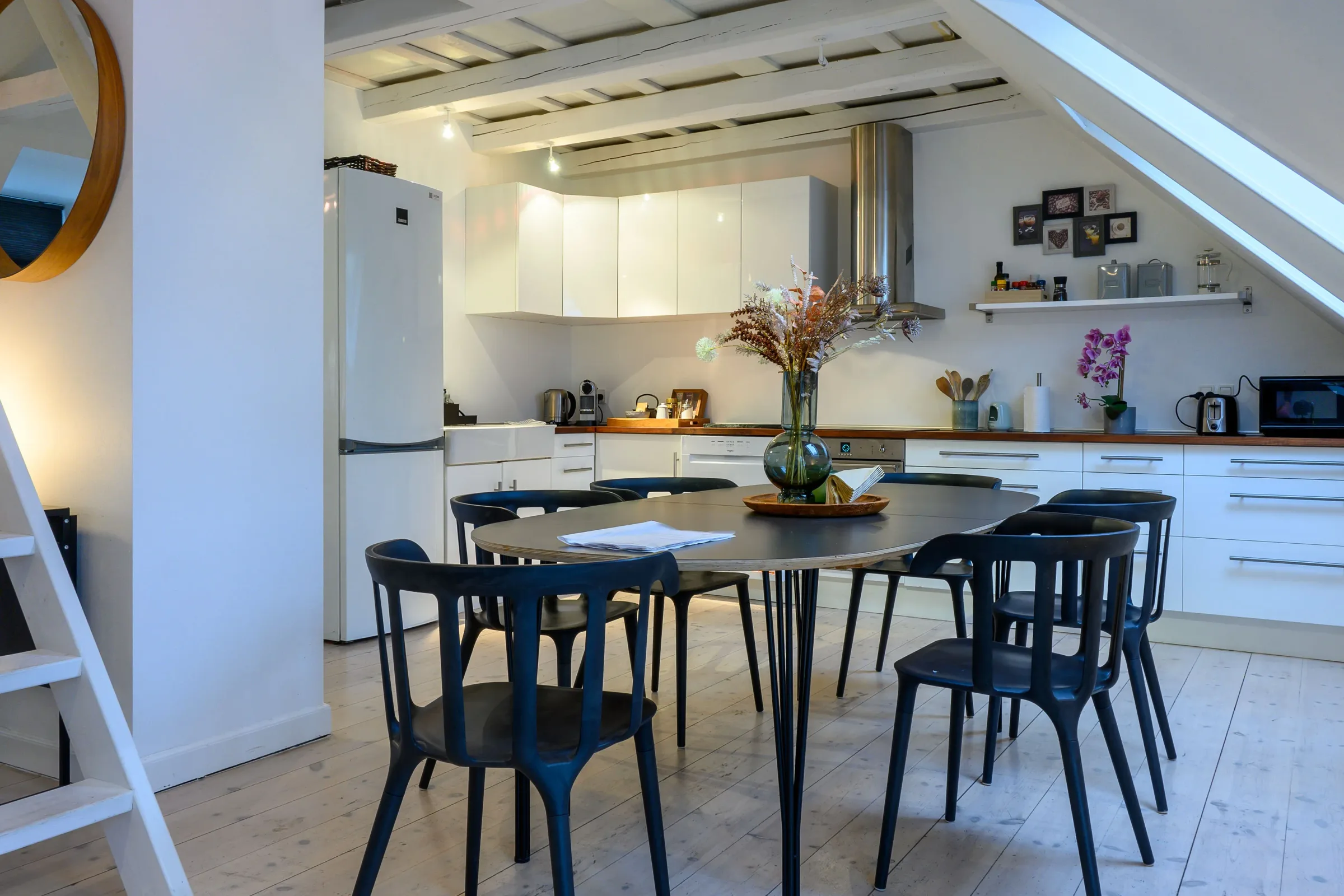 Loft dining area and open kitchen under a sloped ceiling — Bright Loft Apartment, Frederiksberg